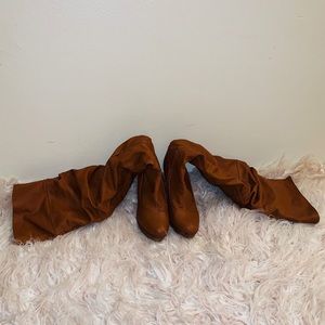 Over the knee long brown leather boots.